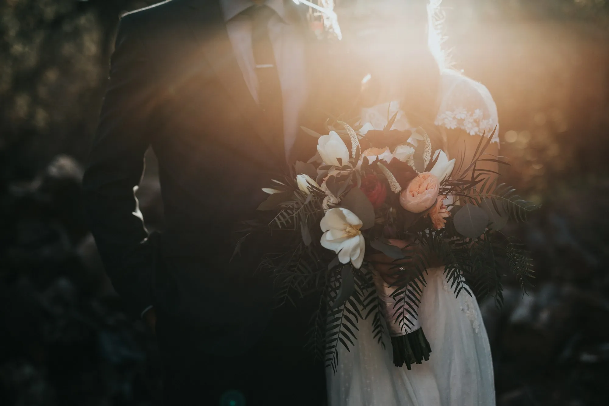 Bride and groom walking through soft evening light