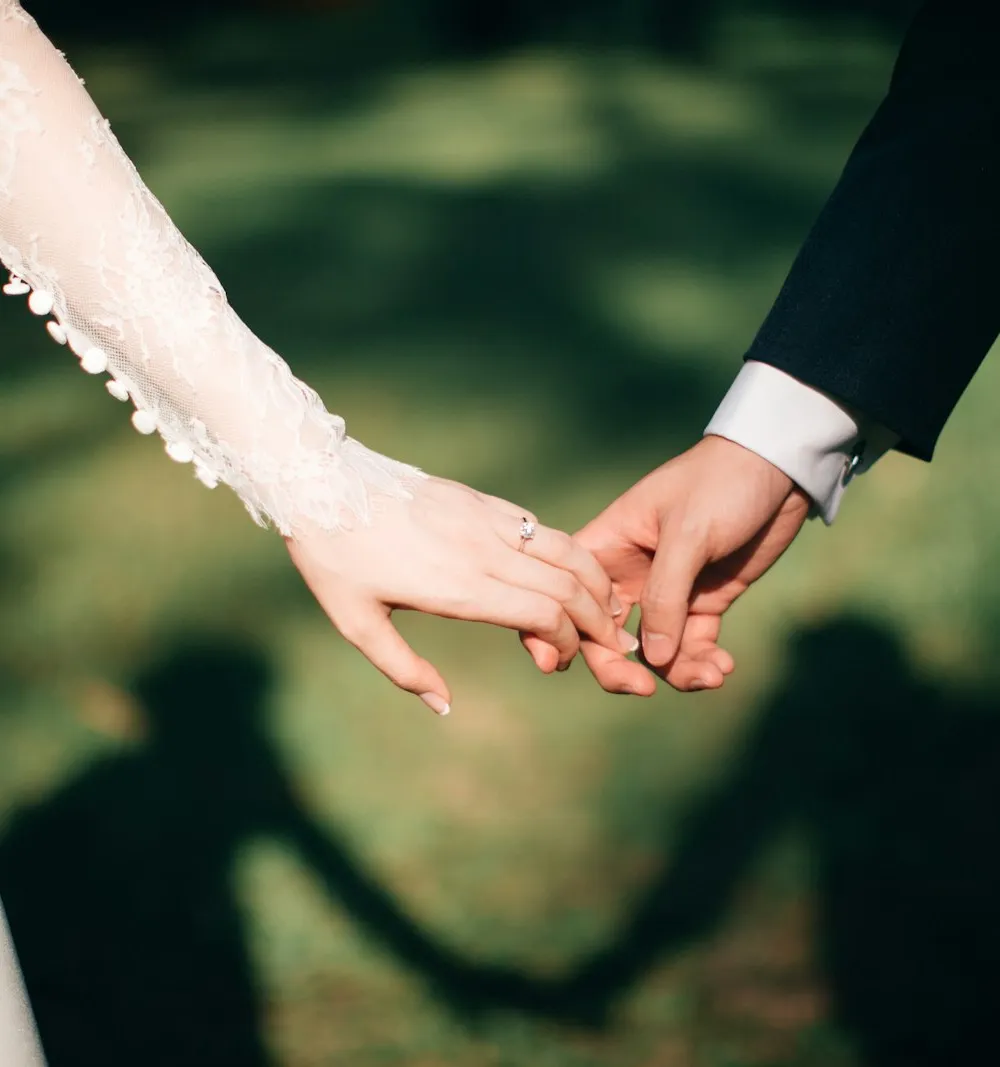 Wedding rings on linen with soft florals